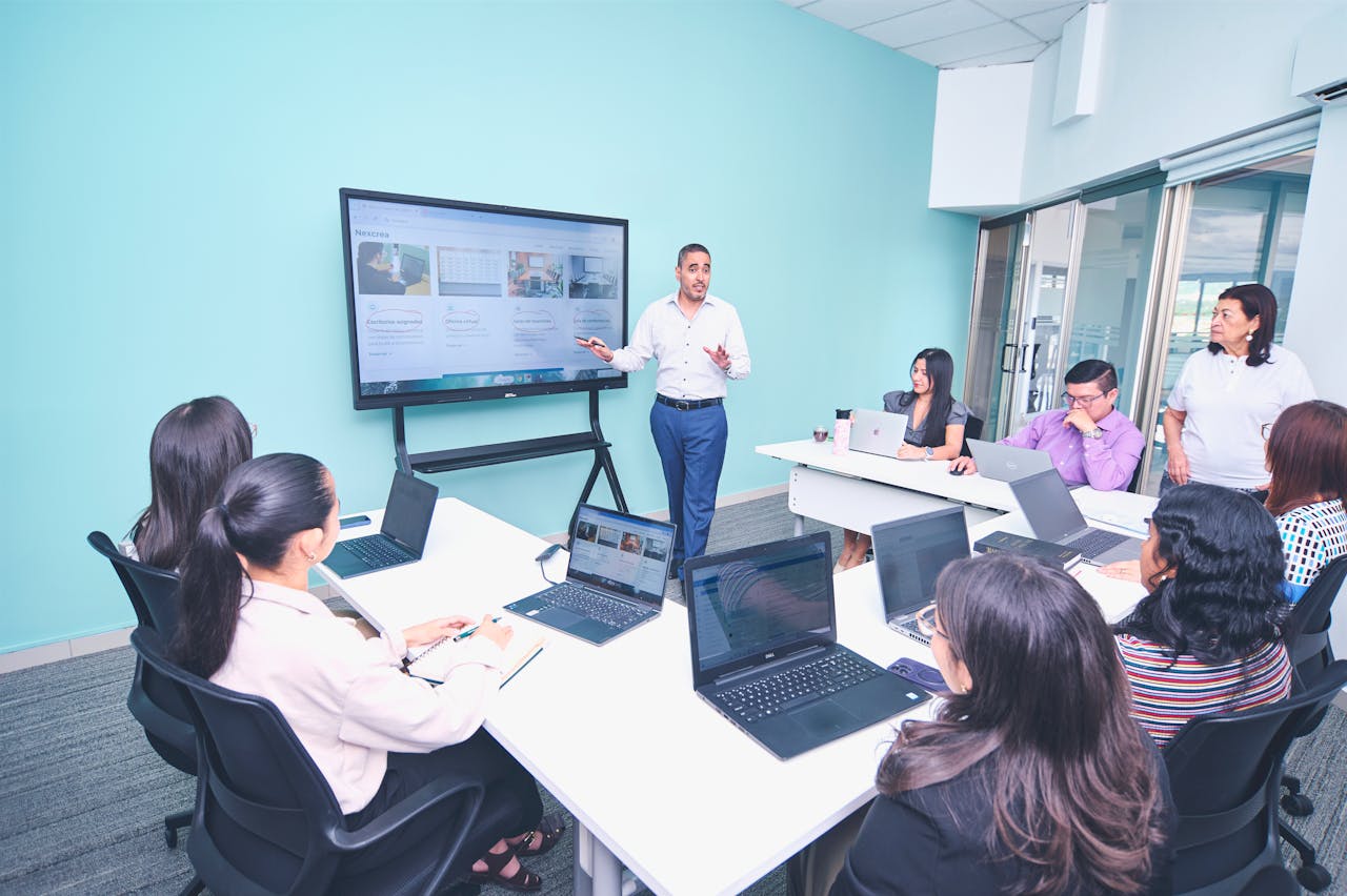 services-03 Team engaged in a presentation at a modern office using digital technology.